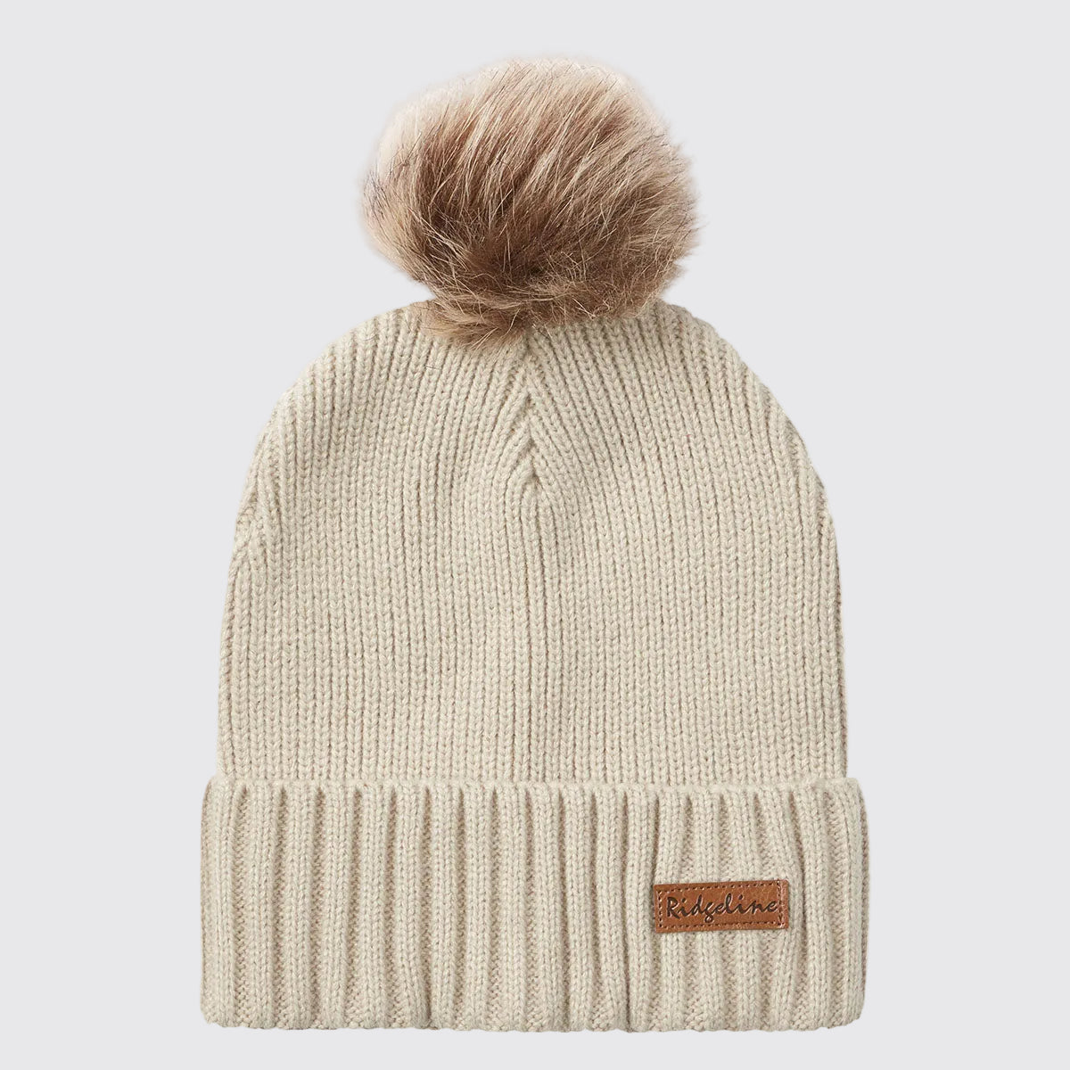 Cream ribbed knit beanie hat with faux fur pom pom, front view.