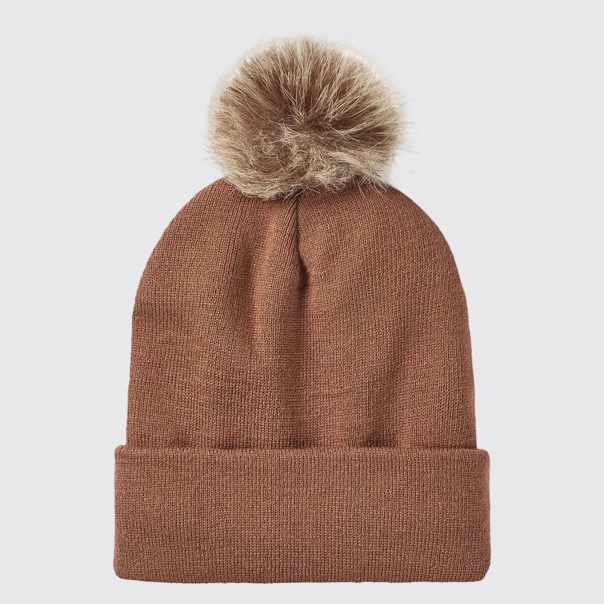 Rear view of a rust-brown ribbed knit beanie with a folded cuff and a large faux-fur pom-pom attached at the crown, displayed against a light grey background. The beanie features a clean, unbranded back with a fine-knit texture and subtle central seam shaping beneath the pom-pom. The fluffy pom-pom adds a stylish cold-weather detail, while the stretch-knit construction and cuffed design highlight the beanie's warmth, comfort, and everyday outdoor appeal.