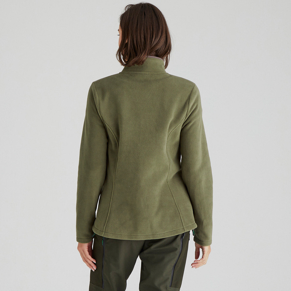 back of person wearing a green jacket on a light grey background