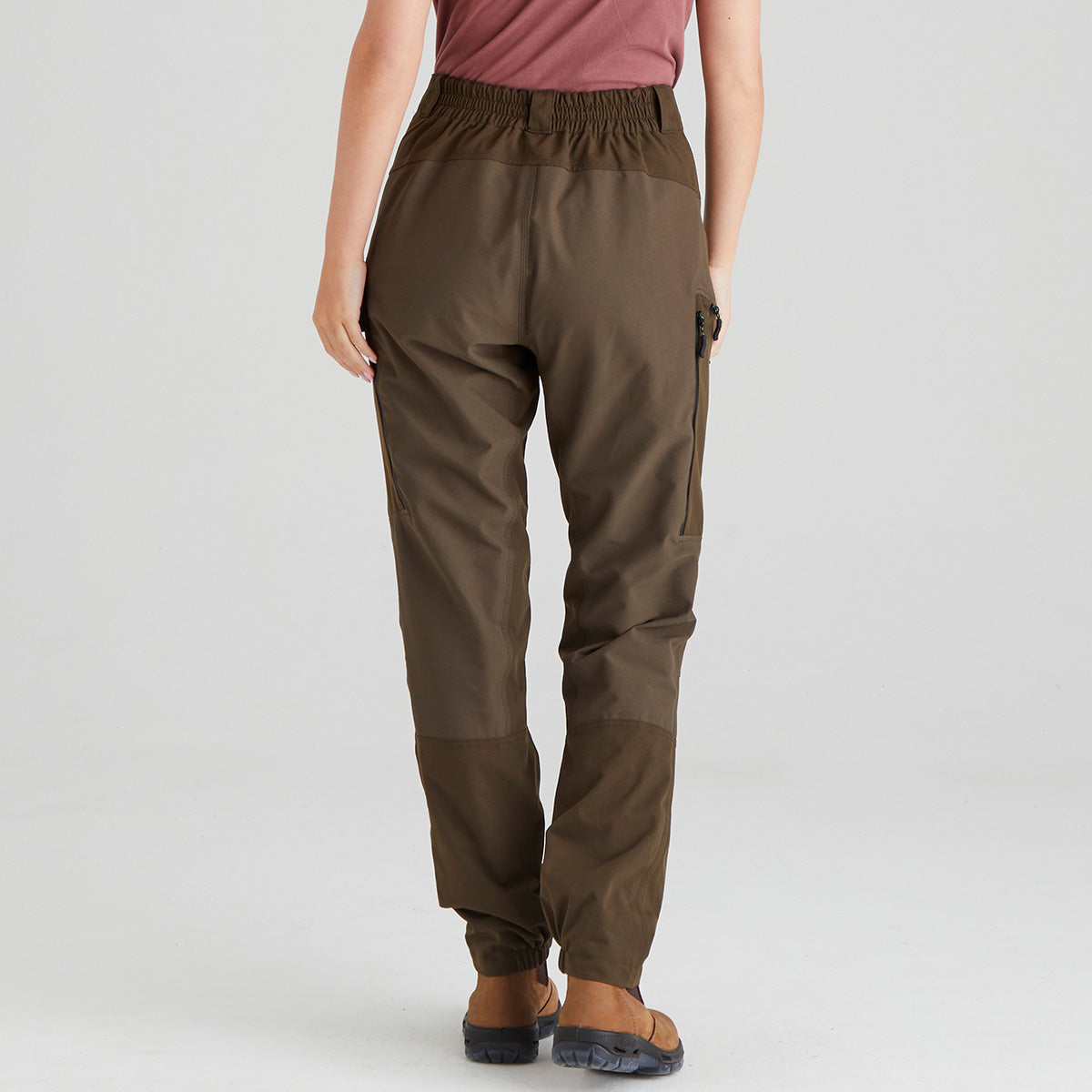 back view of brown pants worn by a person on a light grey background