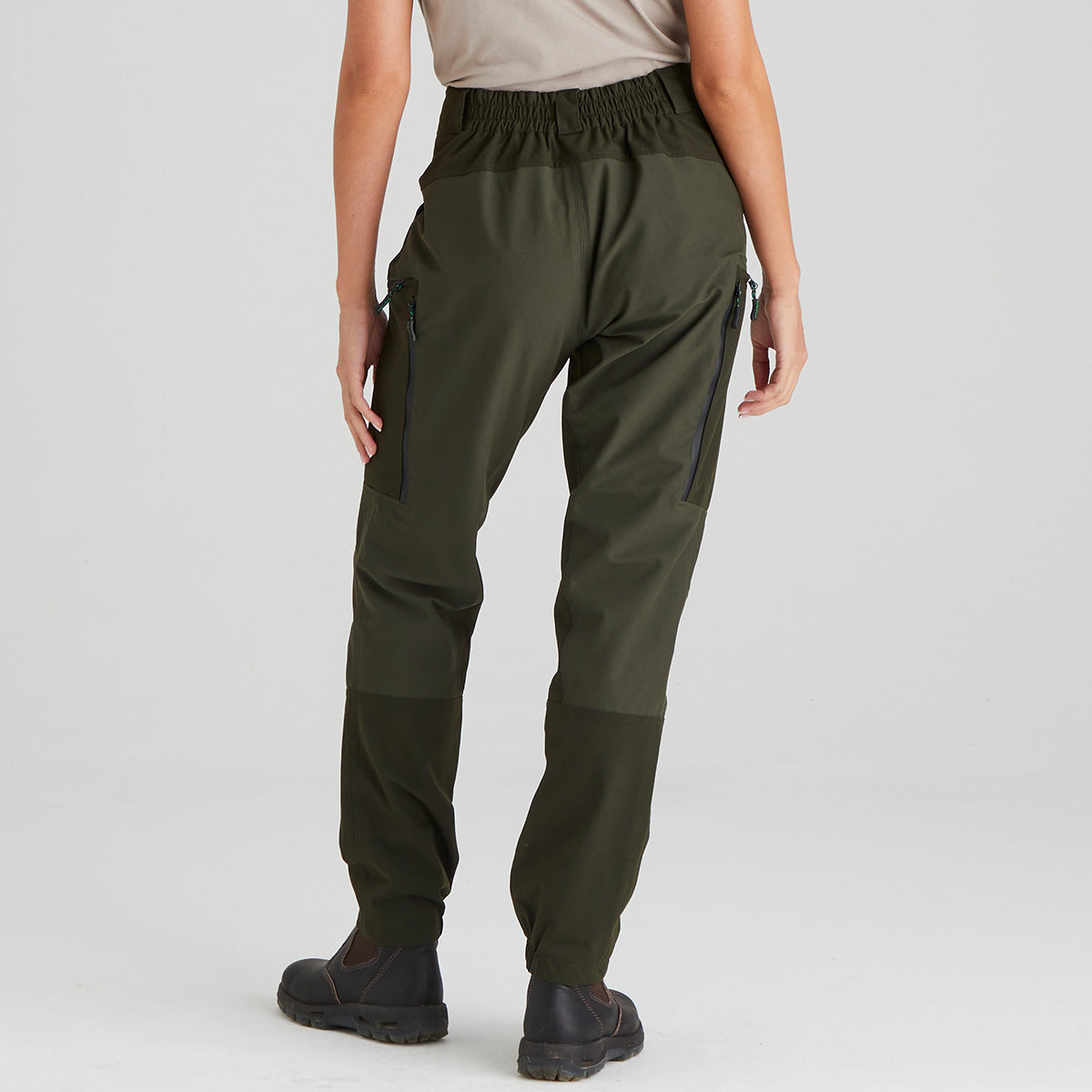 Person wearing green cargo pants on a white background