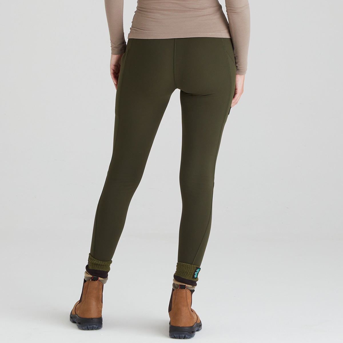 back view of person wearing olive green leggings on a white background