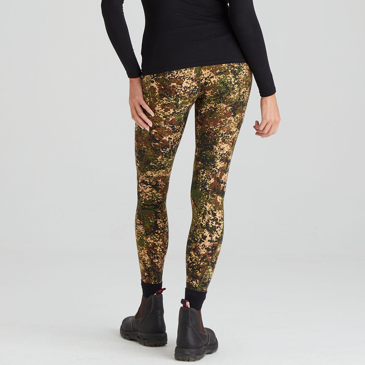 Camouflage leggings worn by a person on a white background