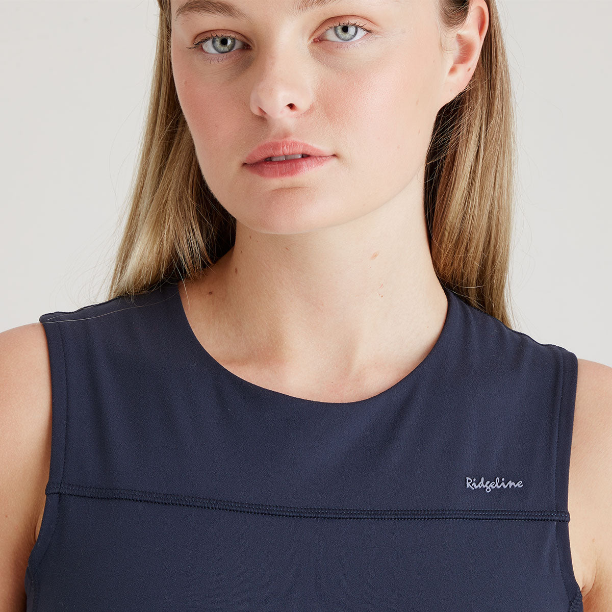 Navy sleeveless top with 'Ridgeline' branding worn by a person on a plain background