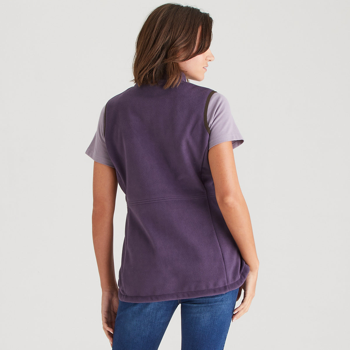 Person wearing a purple shirt with a plain background