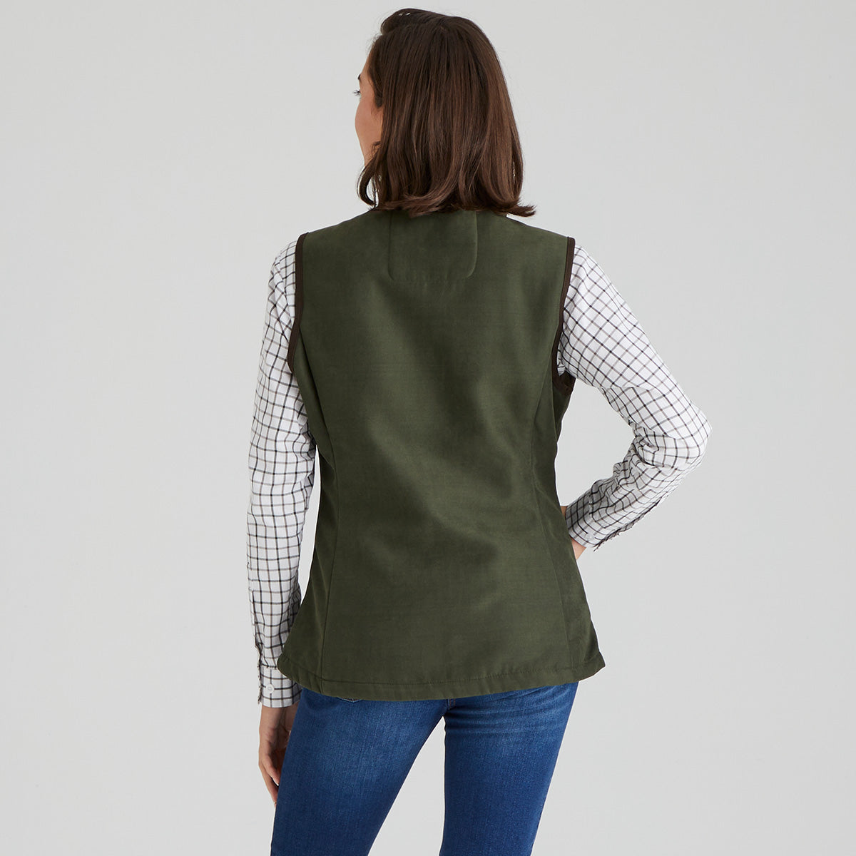 back view woman wearing green moleskin gilet with a checked shirt
