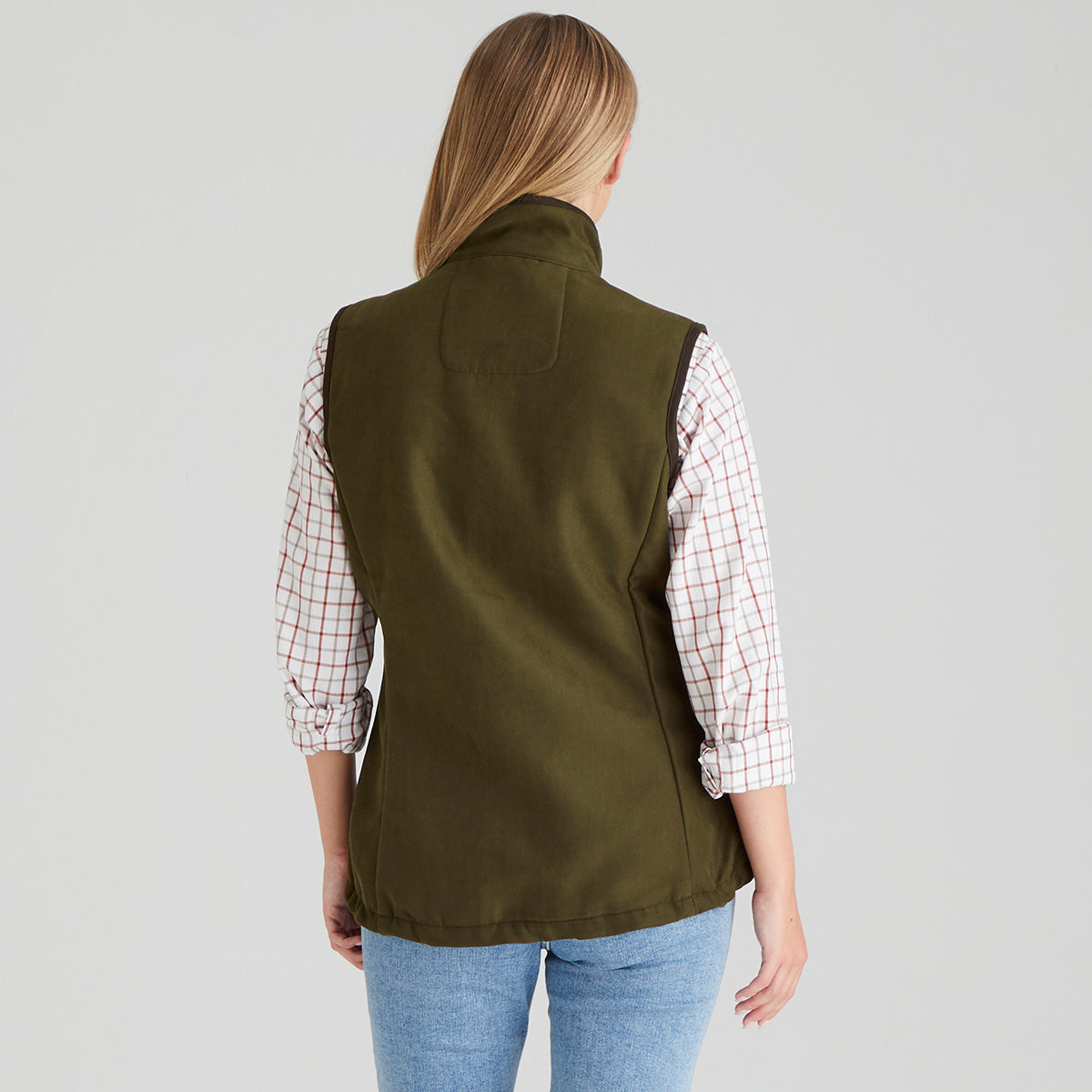 Back view of Woman wearing brown moleskin gilet with checked shirt