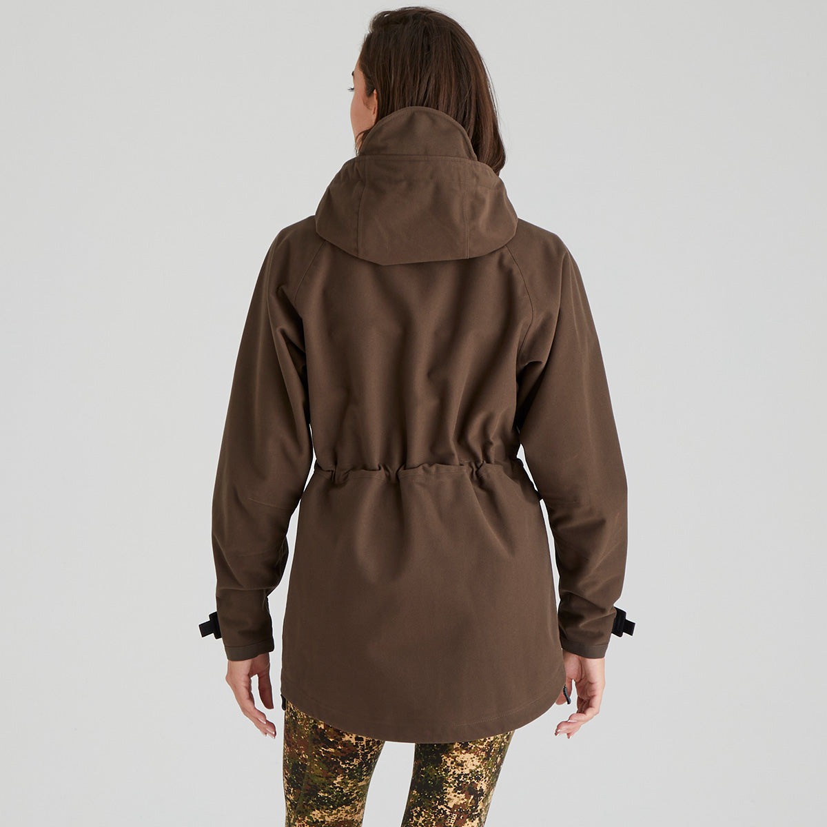 back view of brown jacket worn by a person on a light grey background