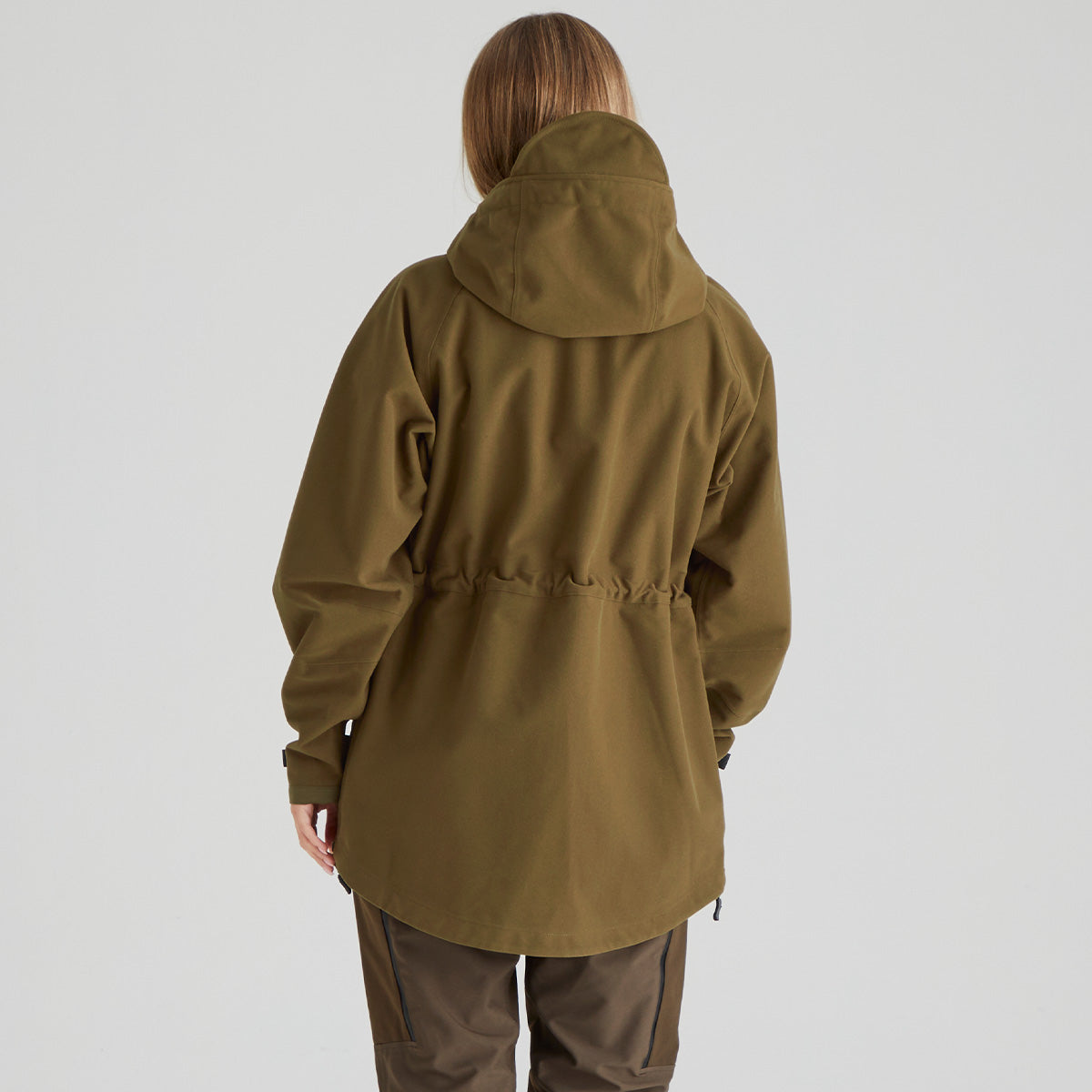 Back of person wearing a green/Brown raincoat on a plain background