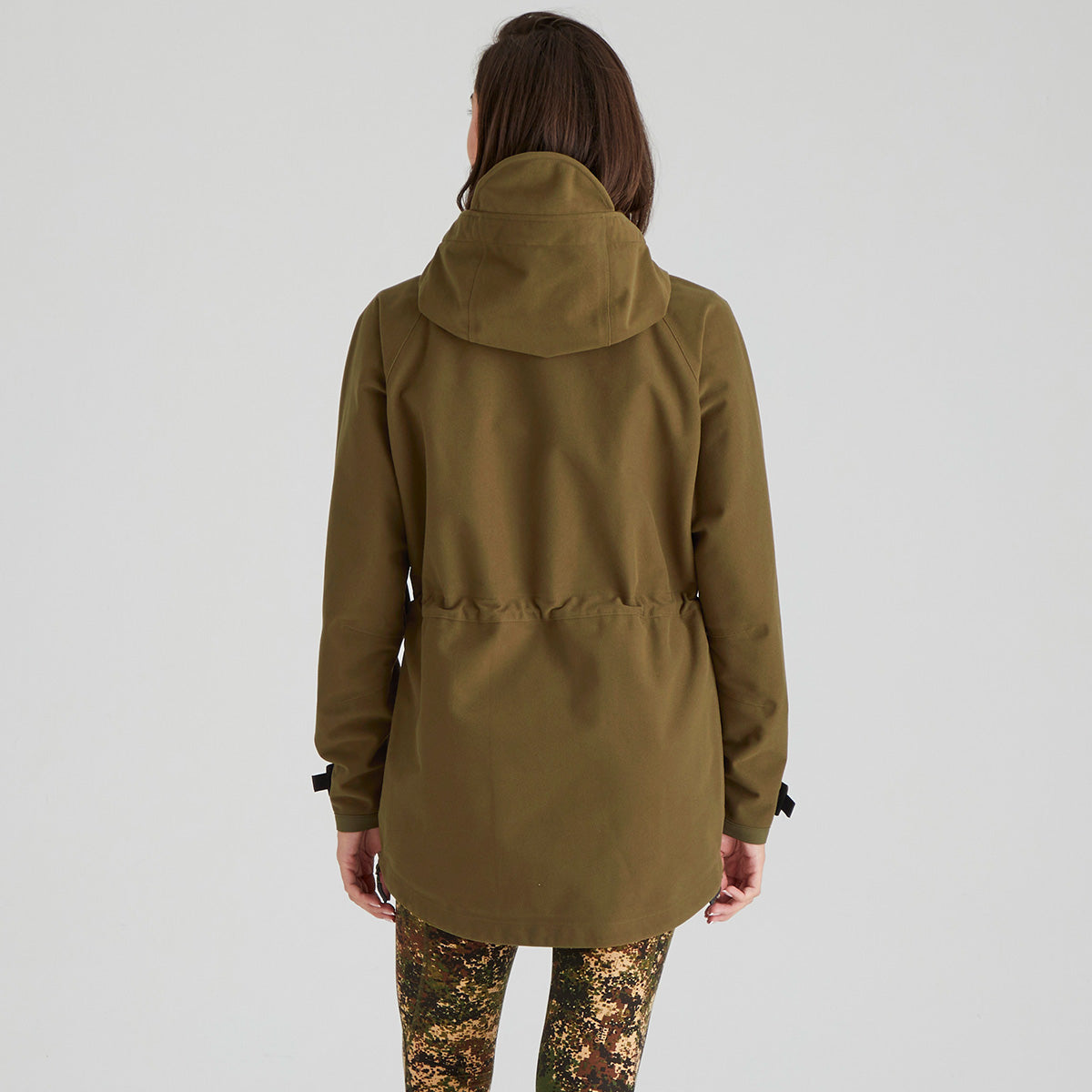 Person wearing a green hooded jacket on a white background