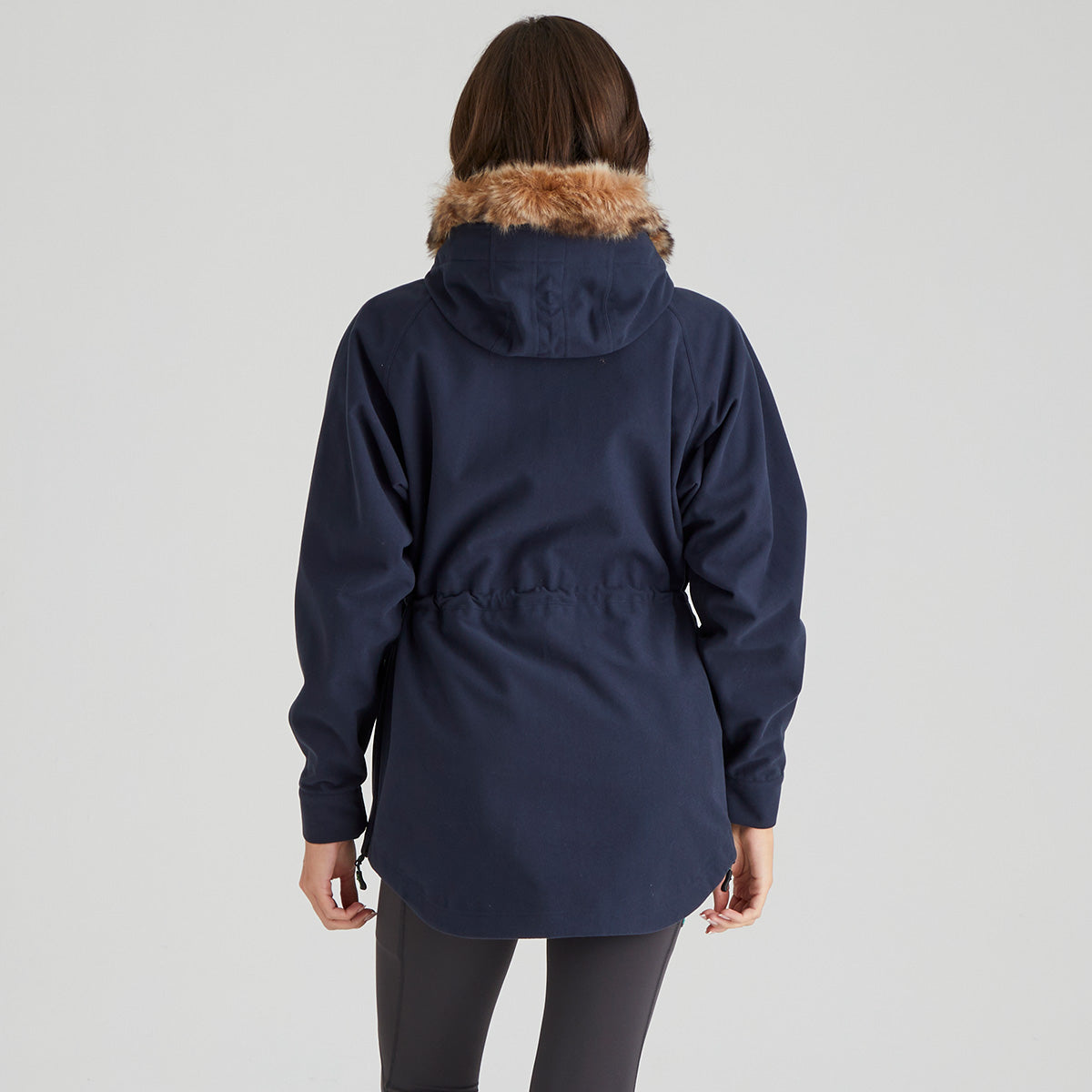 Navy blue parka with fur trim on a grey background