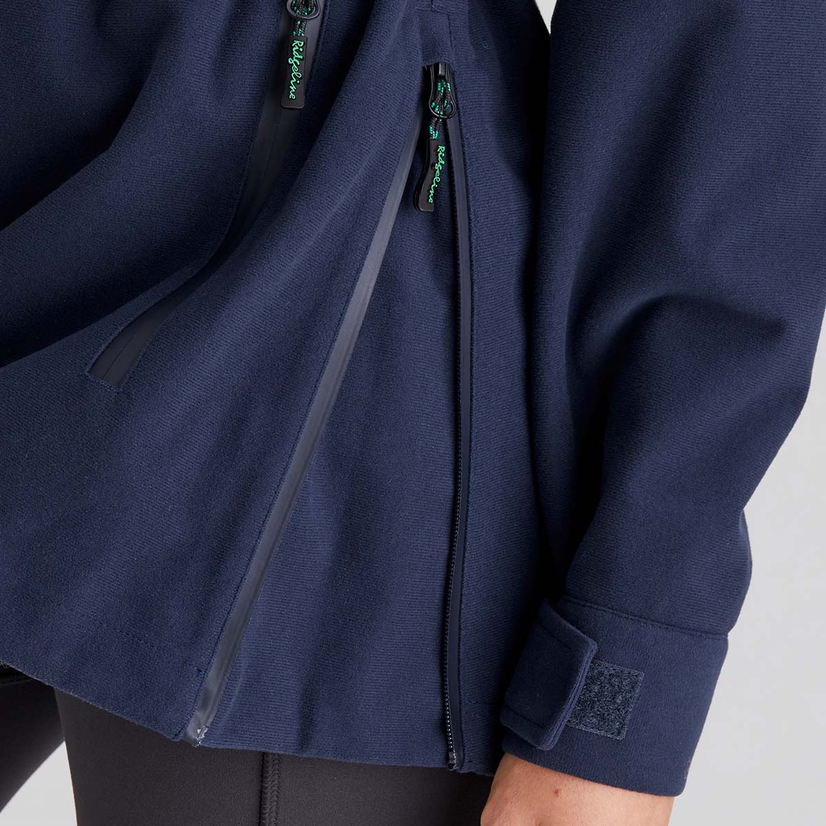 Navy blue jacket with a zipper on a light grey background