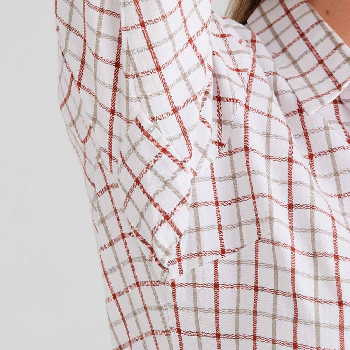 Close-up of a orange and white checkered shirt on a plain background