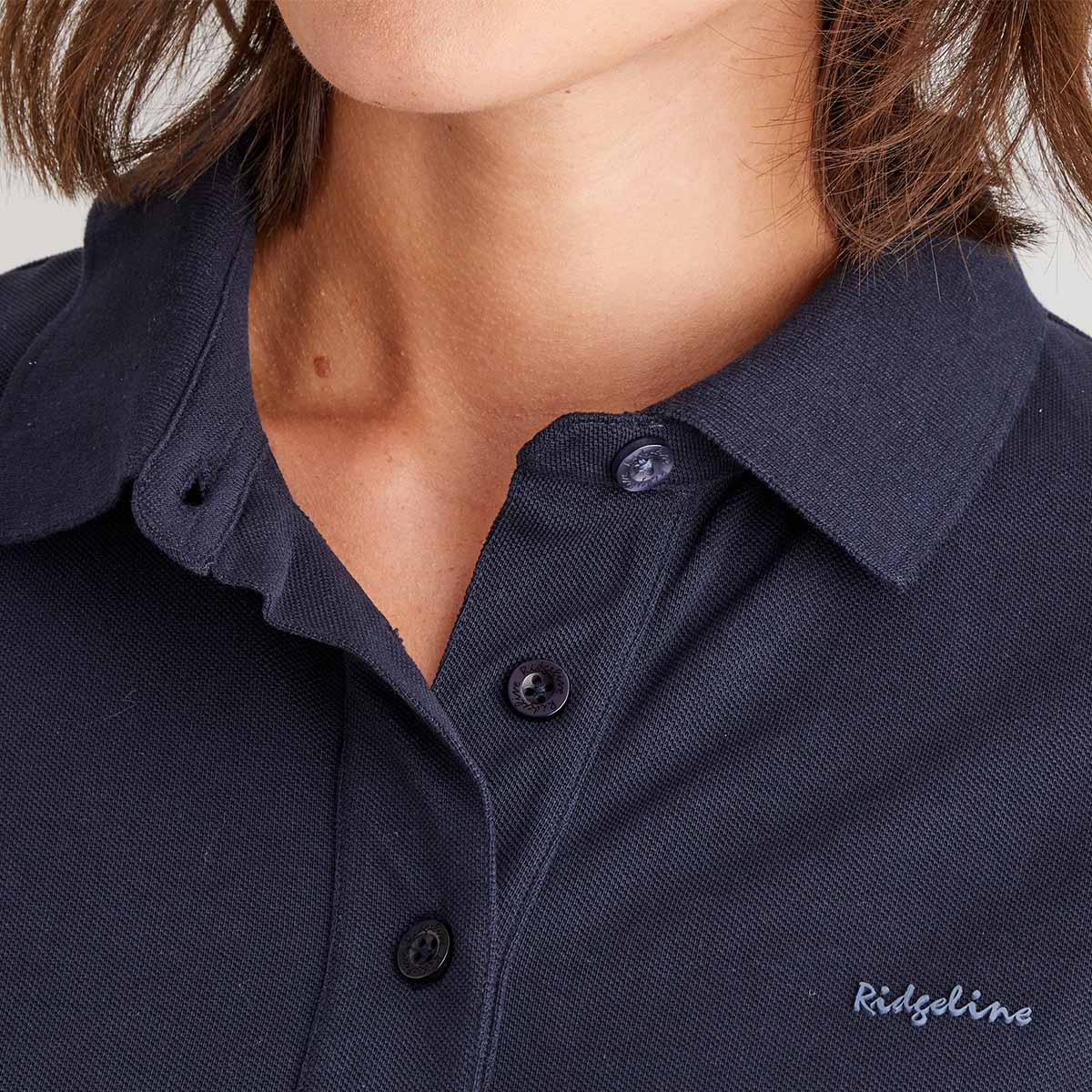 Navy blue polo shirt with brand logo on a plain background