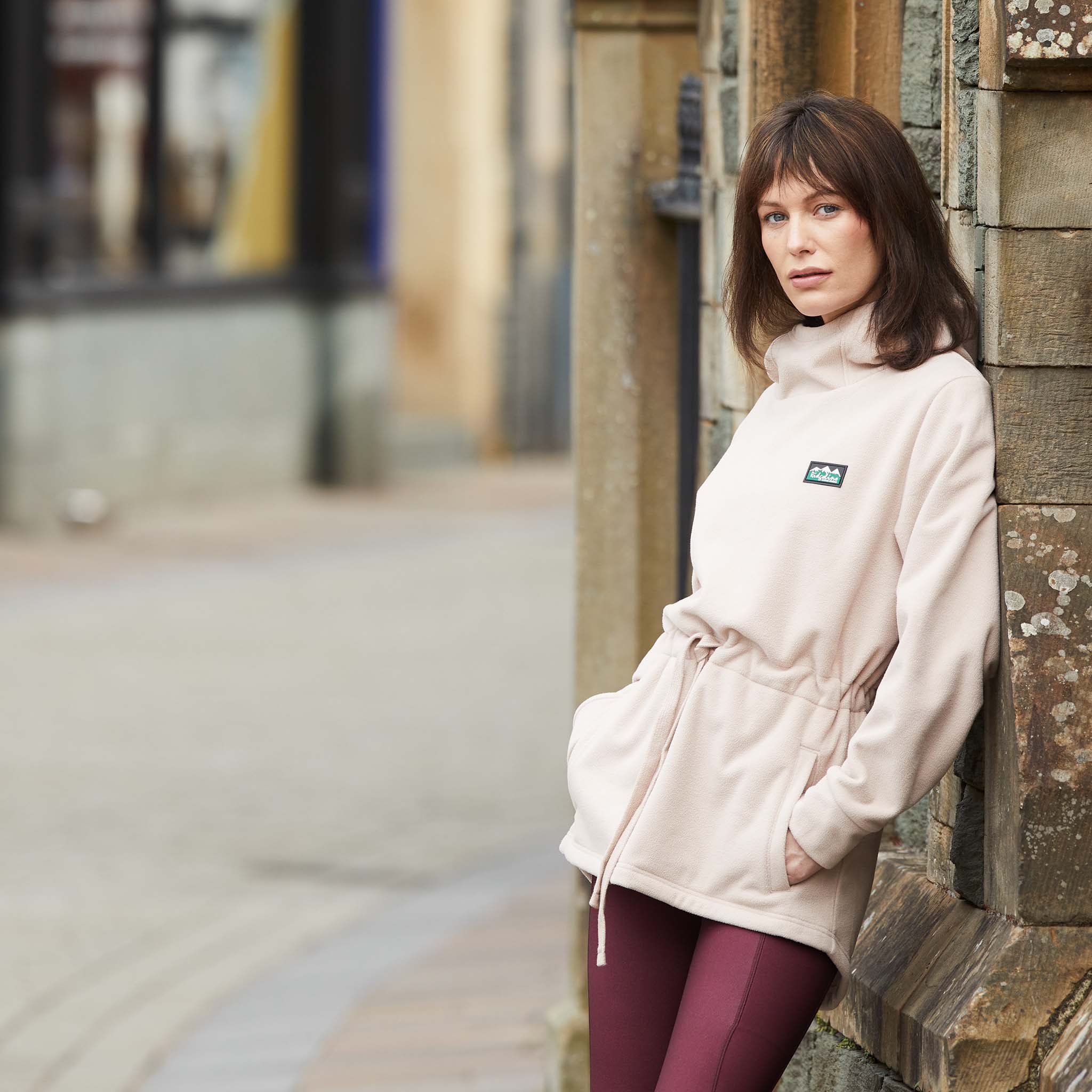 Women Wearing Ridgeline Salt Marsh Fleece leaning against a brick wall