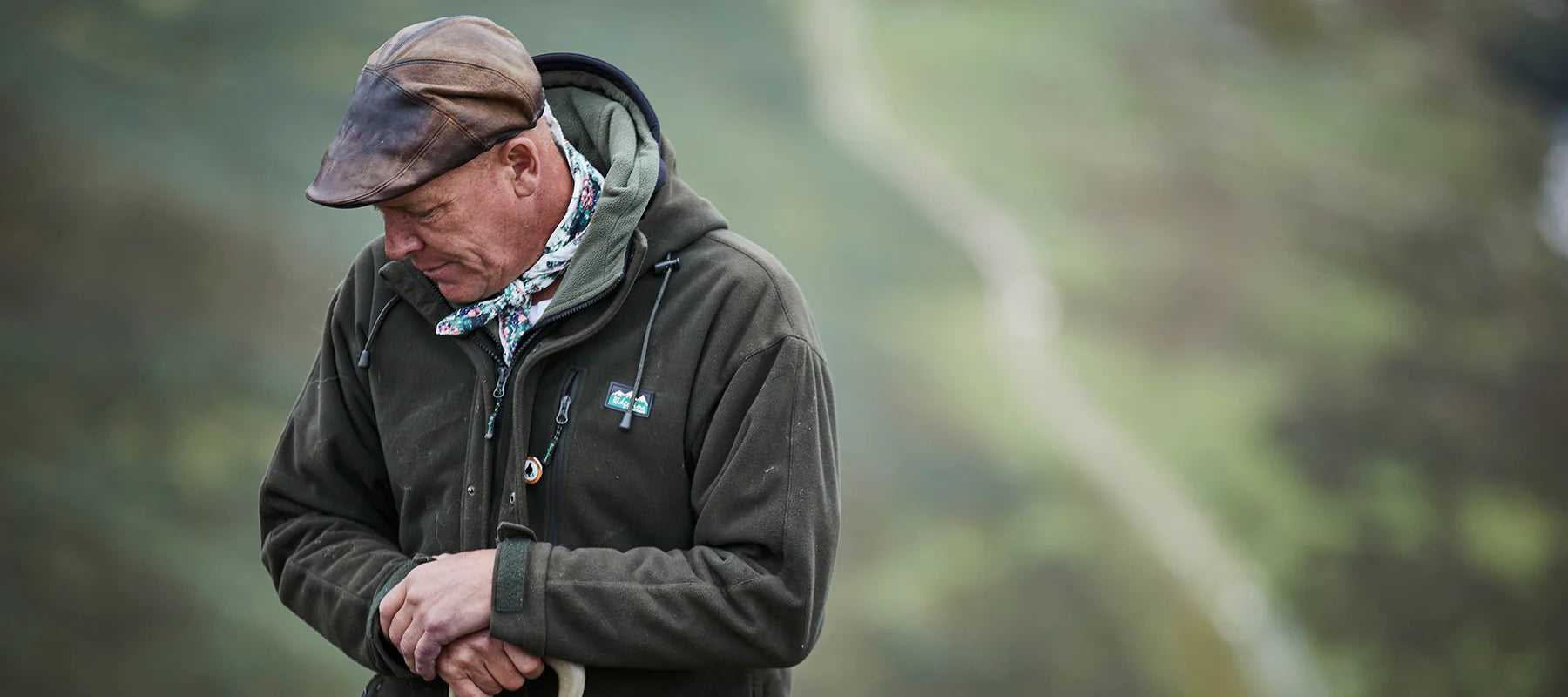 Man wearing Ridgeline jacket standing in field