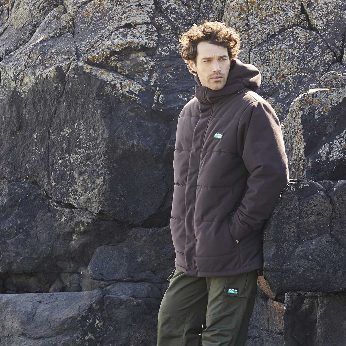 Dark brown padded hooded Ridgeline jacket with full zip front and side pockets, worn outdoor model view