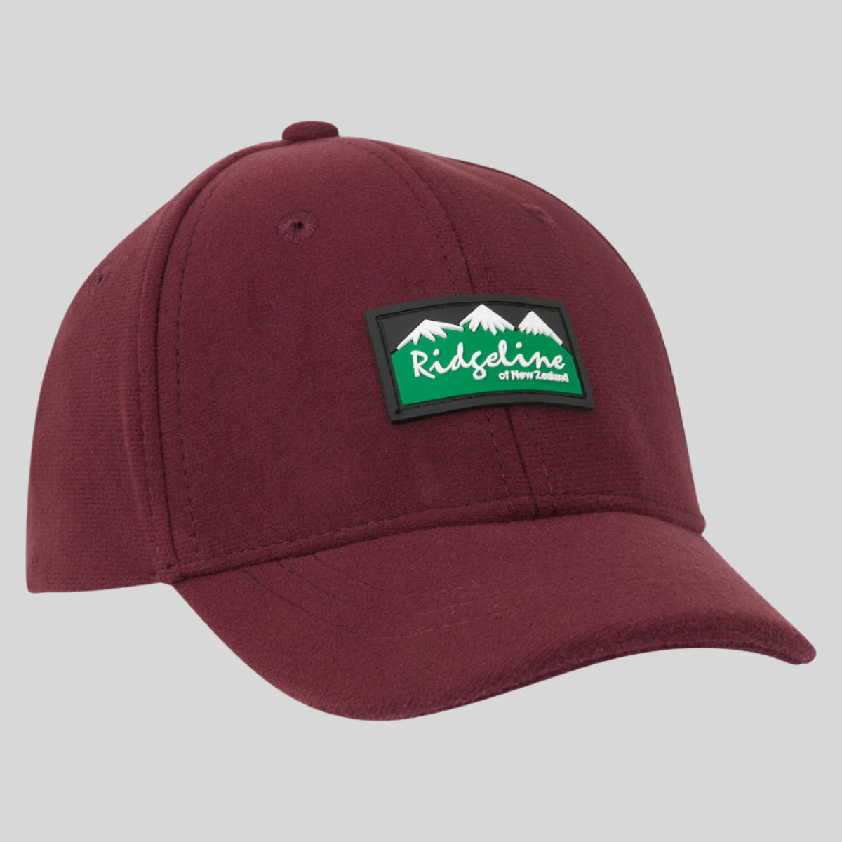 A red kids' baseball cap with a 'Ridgeline Clothing' logo on the front.