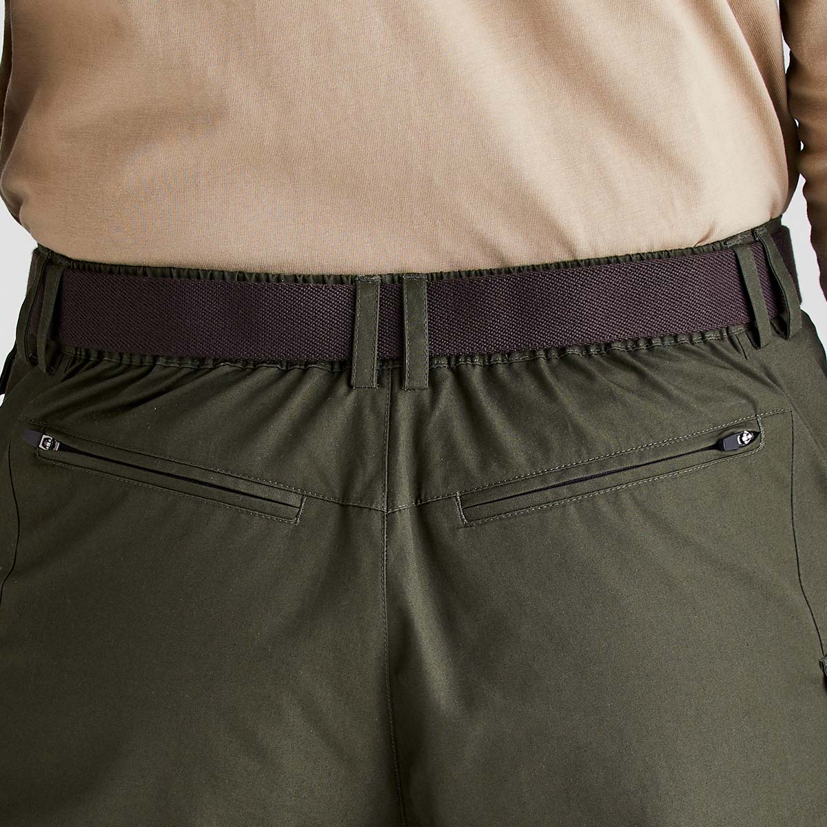 Brown woven fabric belt worn with trousers, back view close-up.