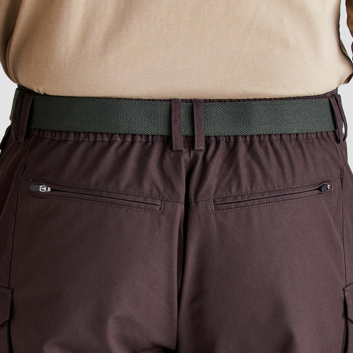 Green woven fabric belt worn with trousers, back view close-up