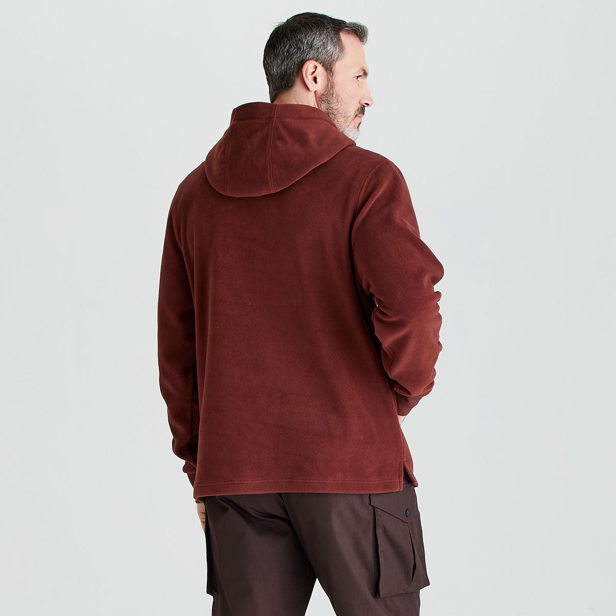 Man wearing a red fleece jacket on a light gray background