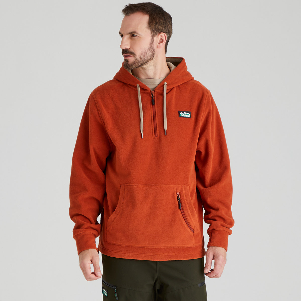 Man wearing an orange fleece hoodie with a Ridgeline Clothing brand logo on a grey background