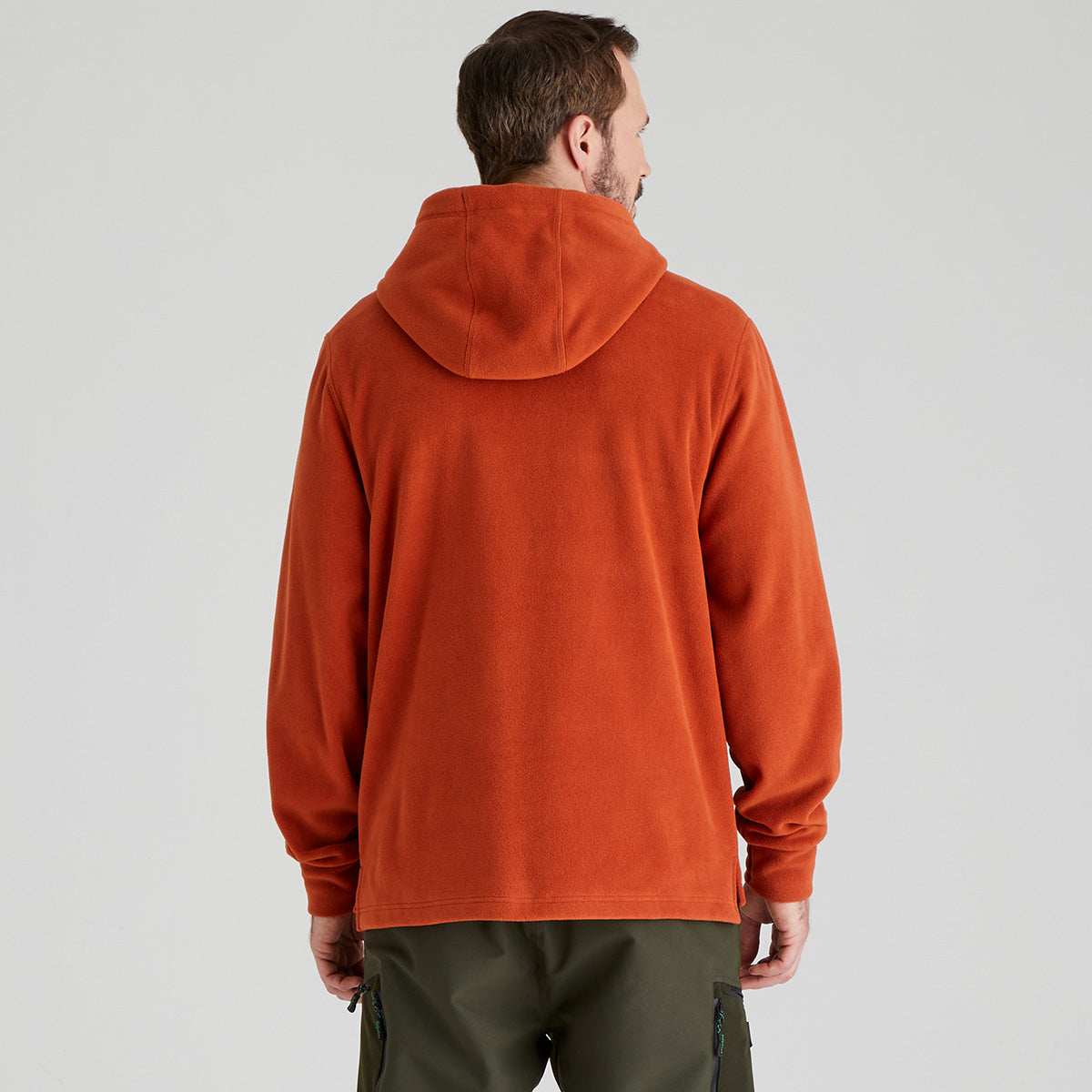 back view of man wearing an orange hoodie on a plain background