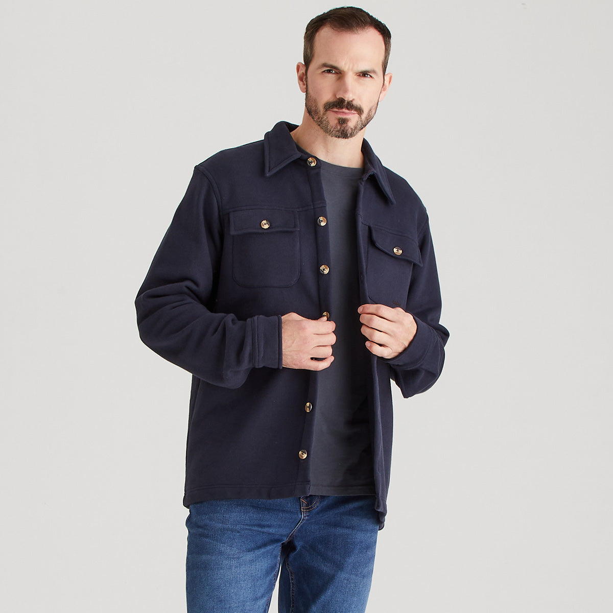 Man wearing a navy jacket on a light gray background