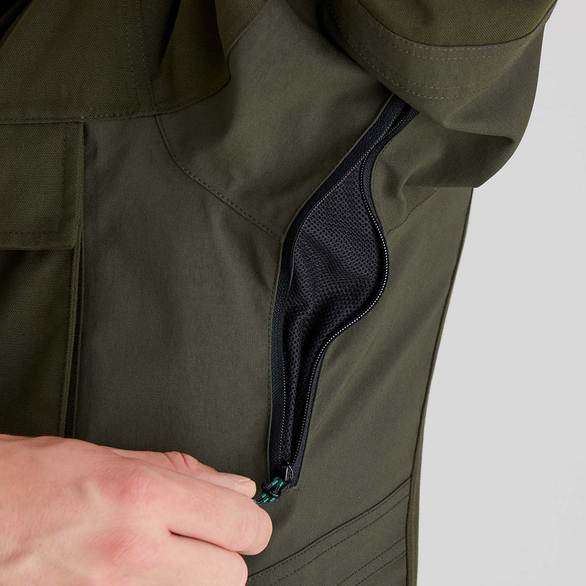 Olive green smock underarm ventilation zip with mesh lining, close-up detail