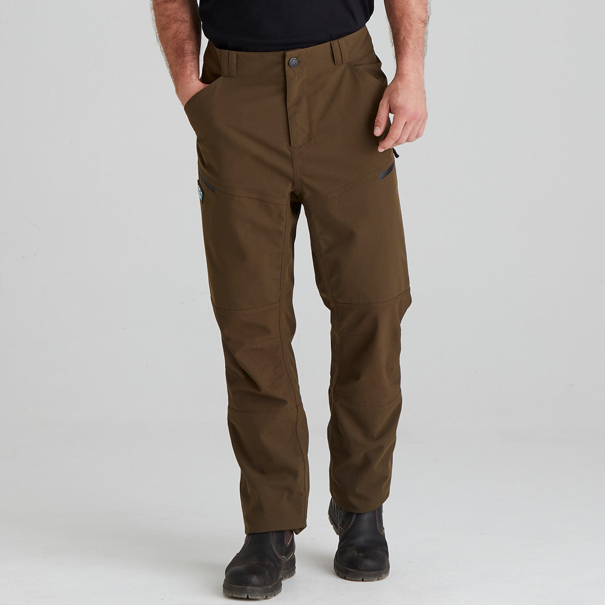 Brown pants worn by a person on a light gray background