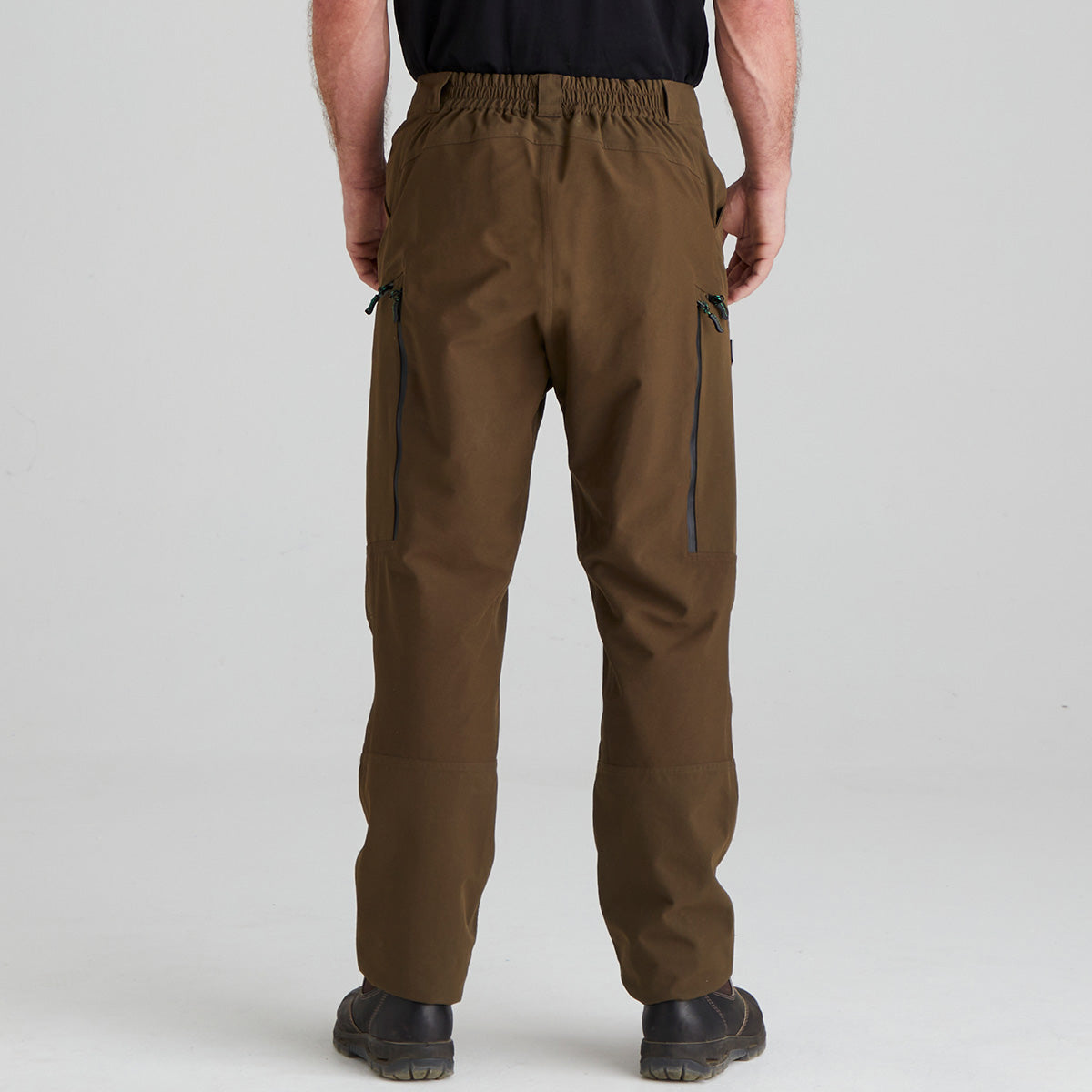 Brown pants worn by a person on a light gray background