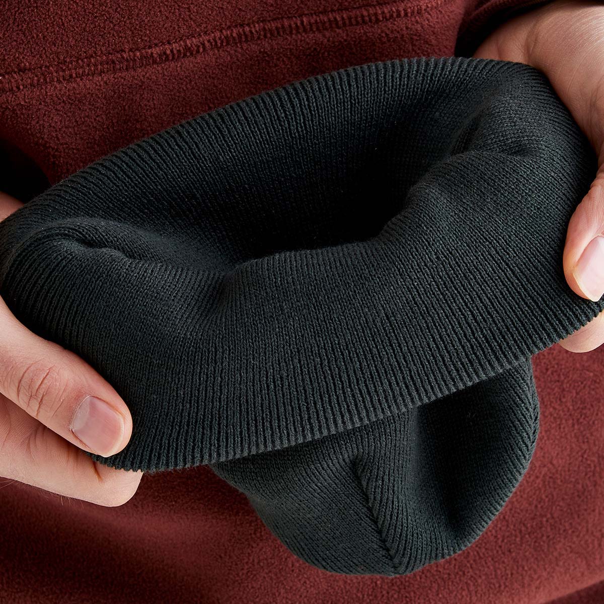 A person showcasing the quality and texture of the Rigeline beanie.