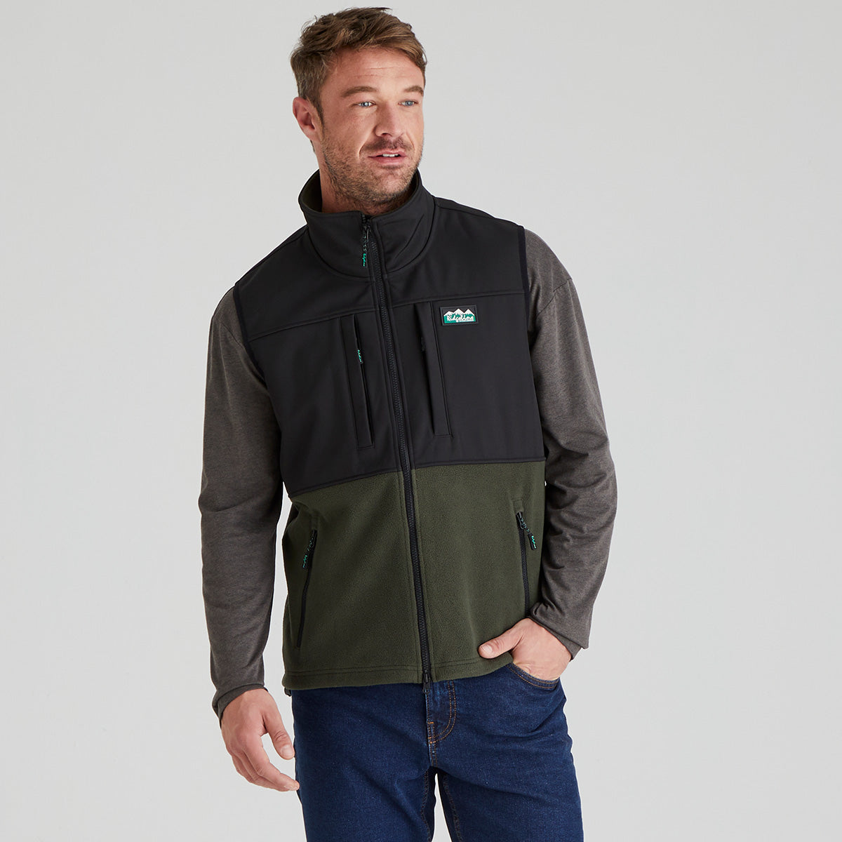 Man wearing a two-tone green & black Windproof fleece gilet with a visible Ridgeline Clothing brand logo on a grey background