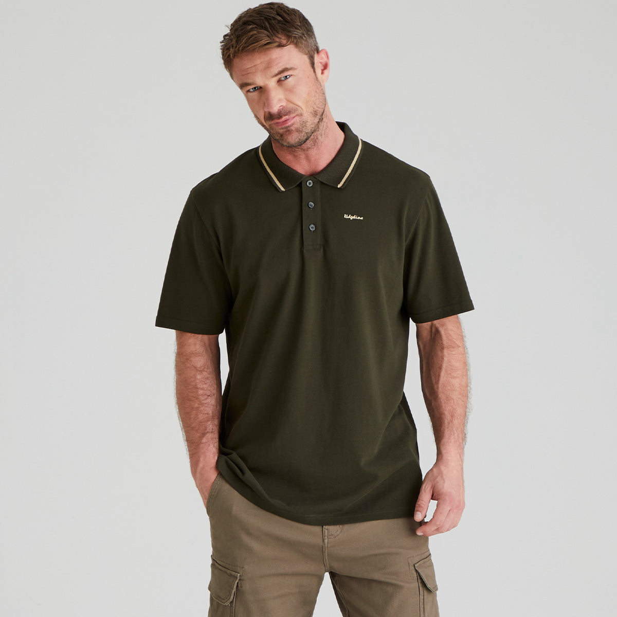 Man wearing dark green polo top