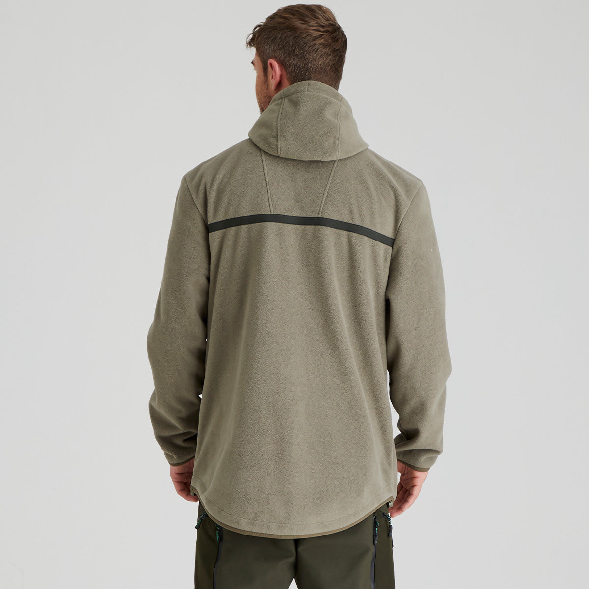 back view of man wearing a green jacket with a black stripe on a light grey background