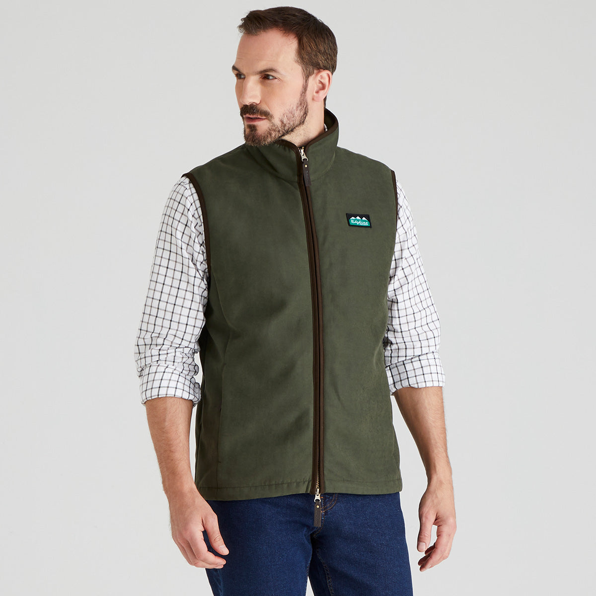 Man wearing Green windproof gilet with checked shirt