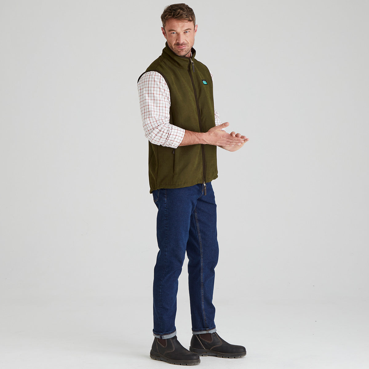 Man wearing Brown windproof fleece with Checked shirt & jeans