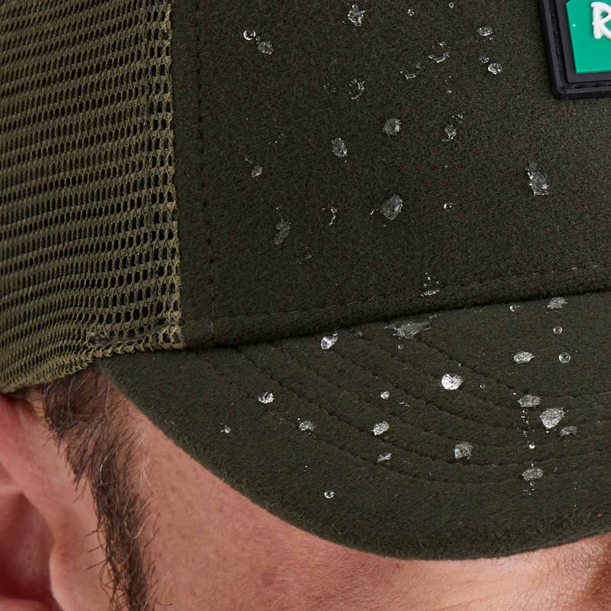 Close-up of a green cap with water droplets on a person's head