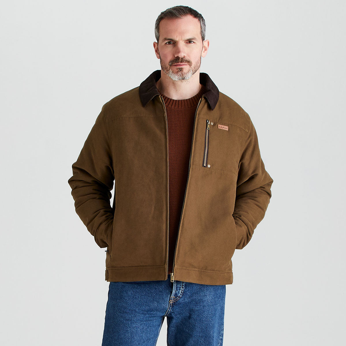 Man wearing a brown jacket with a plain background