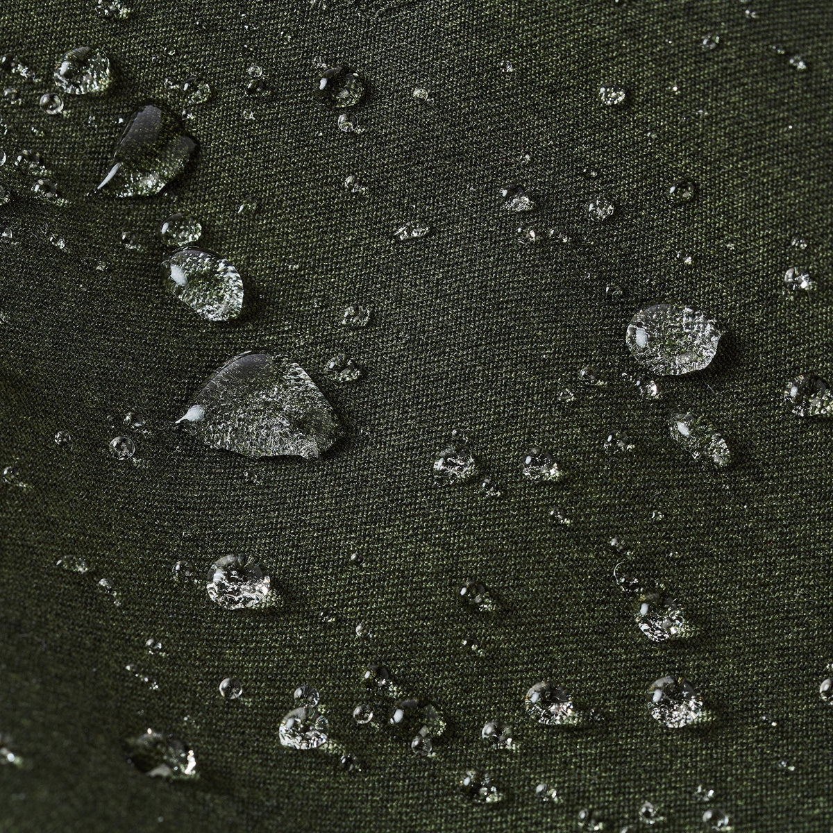 Close-up of water droplets on a textured dark surface