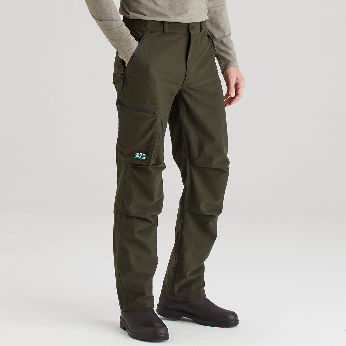 Person wearing green hiking pants on a white background