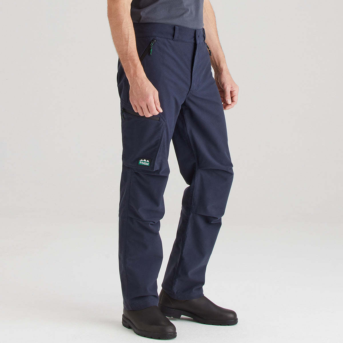 Navy blue pants worn by a person on a light gray background
