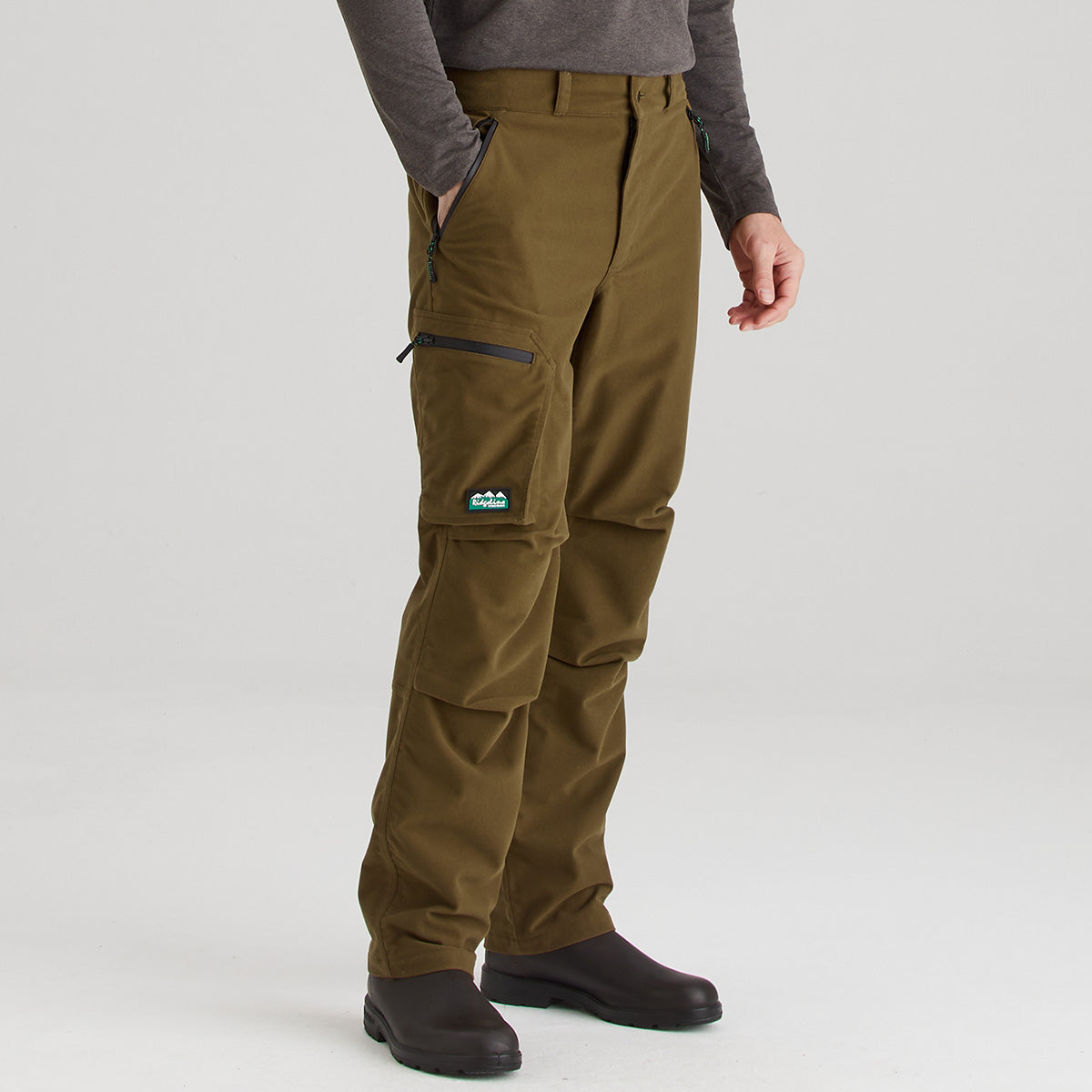 Brown cargo pants worn by a person on a white background