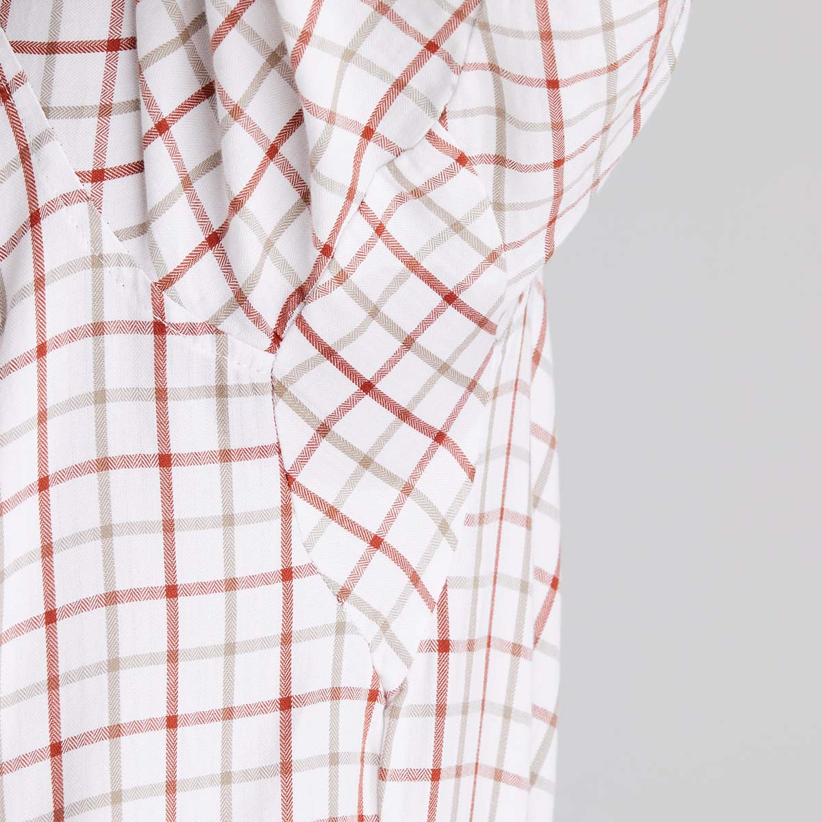 Close-up of a orange and beige checkered fabric on a grey background
