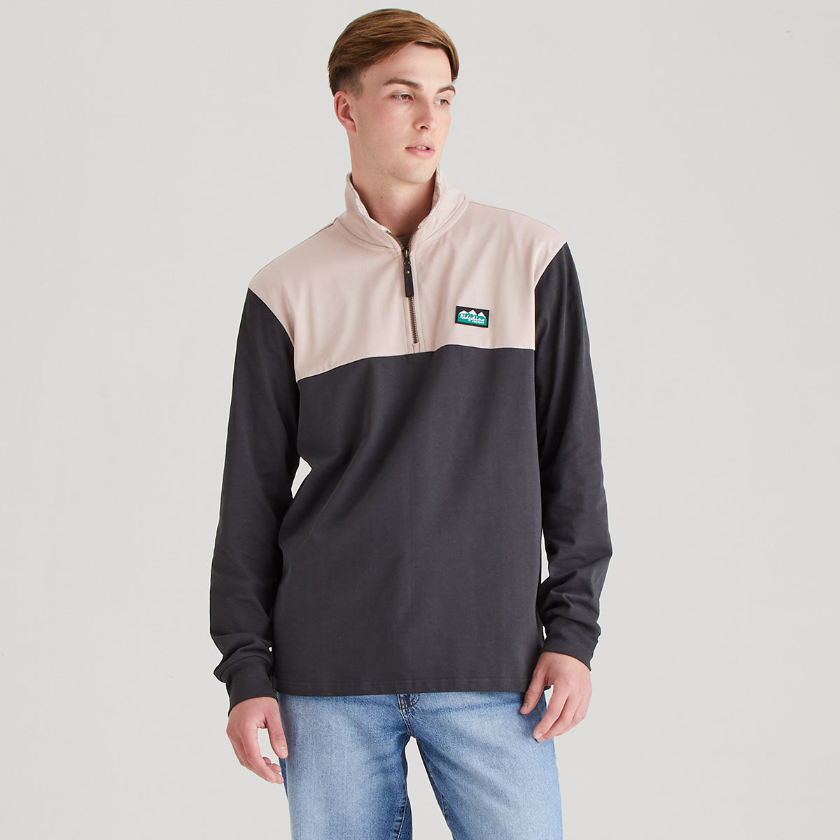 Man wearing two tone rugby shirt with grey background