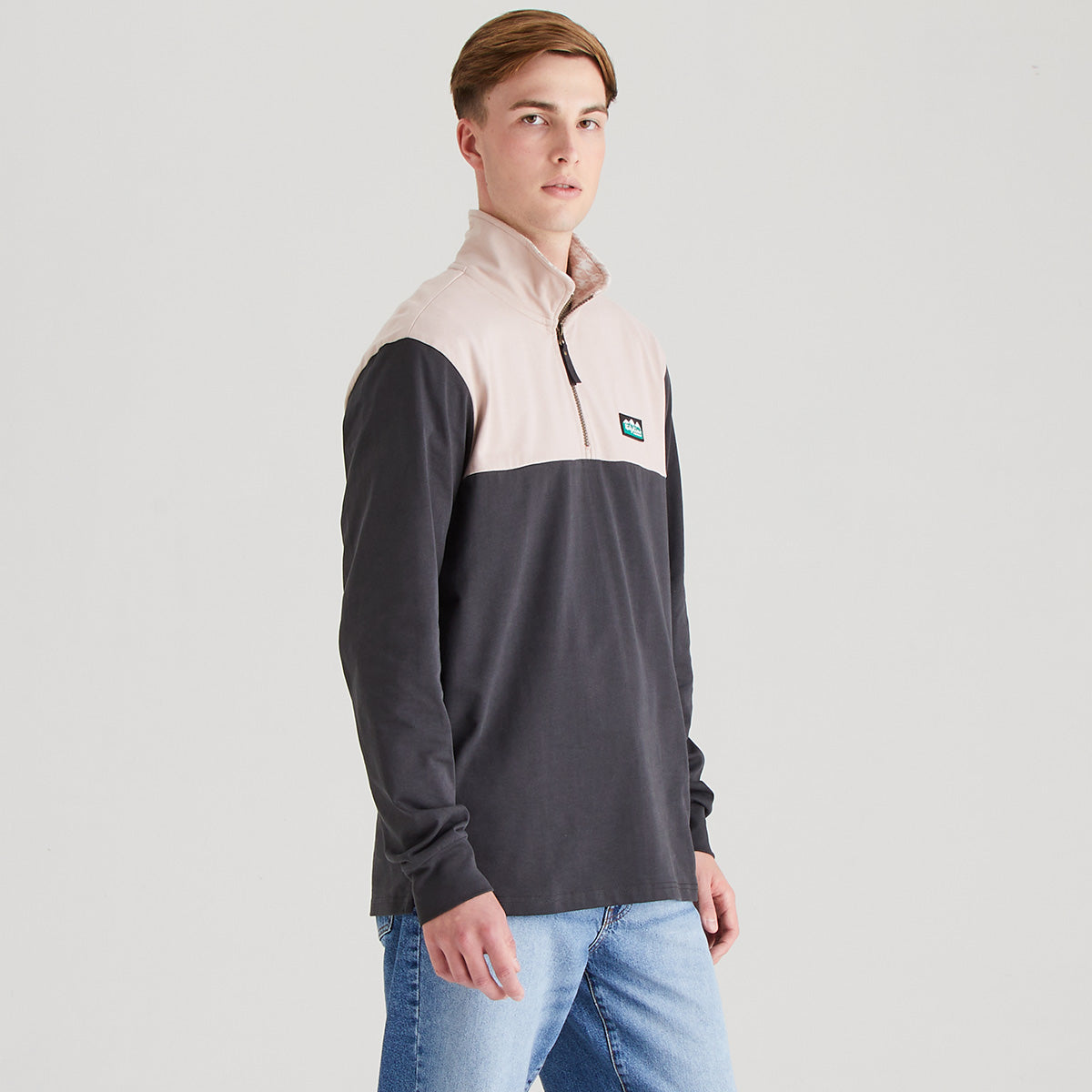 Man wearing two tone rugby shirt with grey background