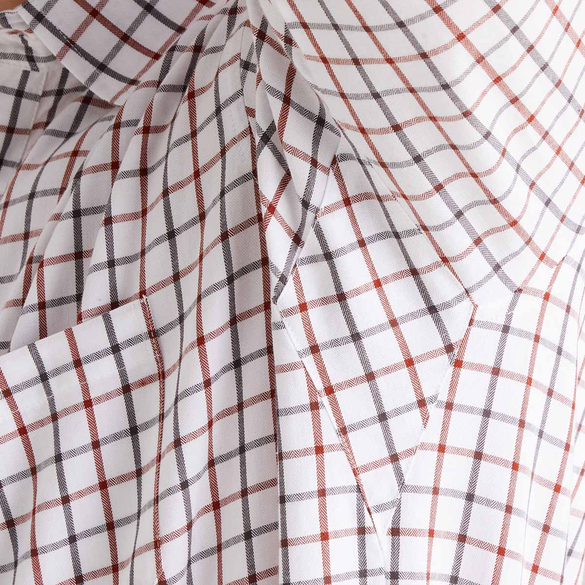 Close-up of plaid fabric with orange, black, and white lines on a white background