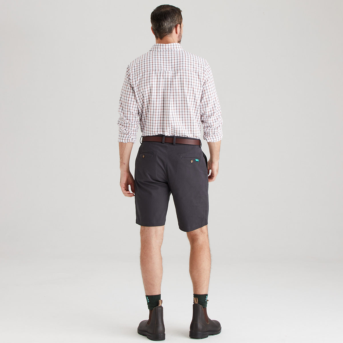 Back view of Man wearing shorts with checkered shirt