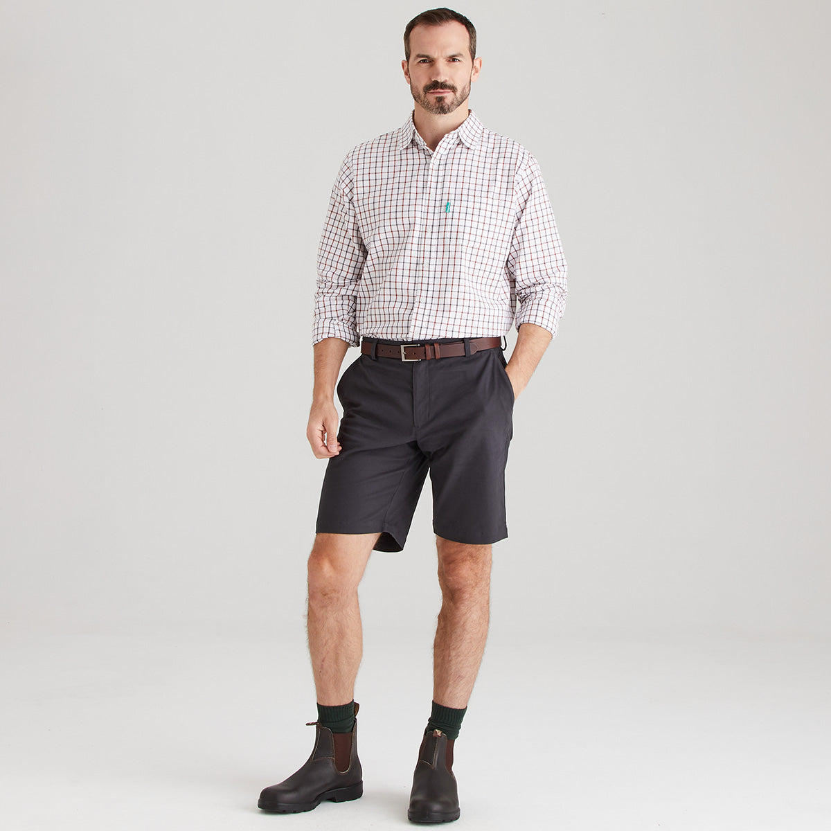 Man wearing shorts with checkered shirt