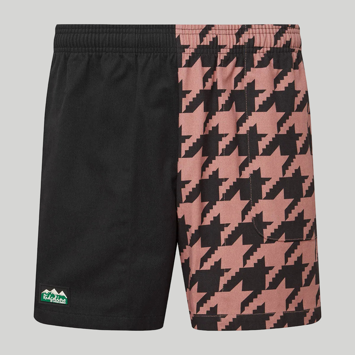 Black and pink houndstooth patterned shorts on a white background